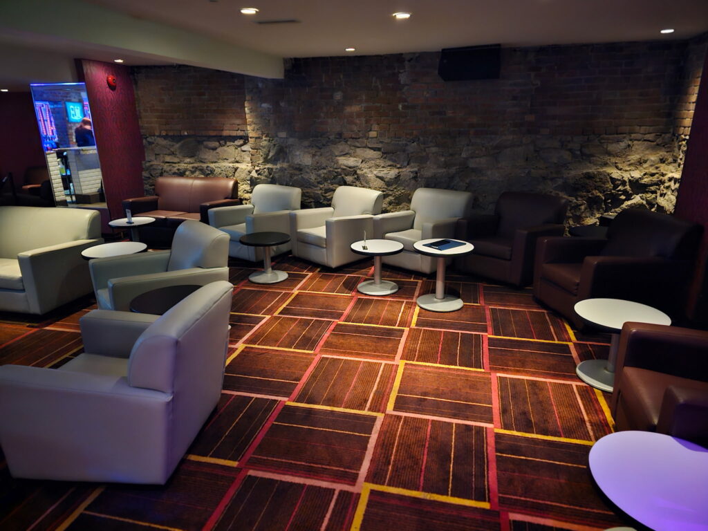 Lounge seating and exposed brick wall inside Alley Katz Windsor